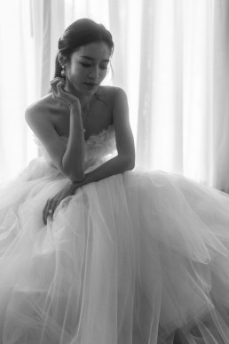Black and white portrait of bride in princess gown with tulle veil