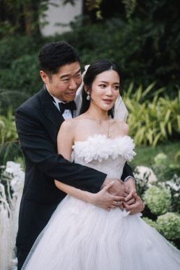 Asian wedding couple embracing in the Four Seasons Chiang Mai tropical garden