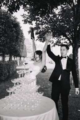 Japanese groom adjusting formal attire before wedding ceremony in Tokyo hotel suite