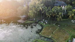 Intimate wedding ceremony beside tropical lagoon and palms in Indonesia, Bali destination wedding videographer storytelling location