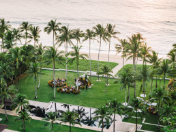 Tropical lawn wedding ceremony setup with palm trees facing the ocean in Bali, Indonesia, destination wedding videographer coverage