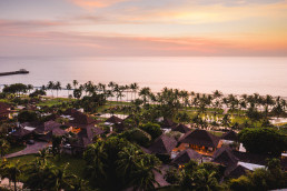 Aerial sunset view of luxury beach resort wedding venue in Bali, Indonesia, destination wedding photographer and videographer location