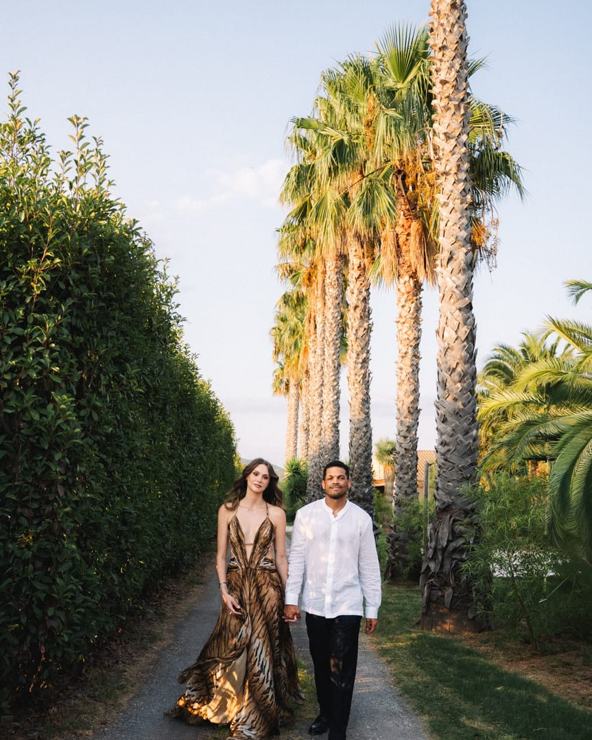 Couple walking between tall palm trees at sunset in Lombok, Indonesia, destination wedding photographer couple session