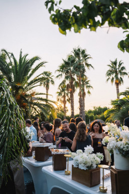 Outdoor wedding dinner reception under palm trees in Bali, Indonesia, destination wedding videographer reception storytelling