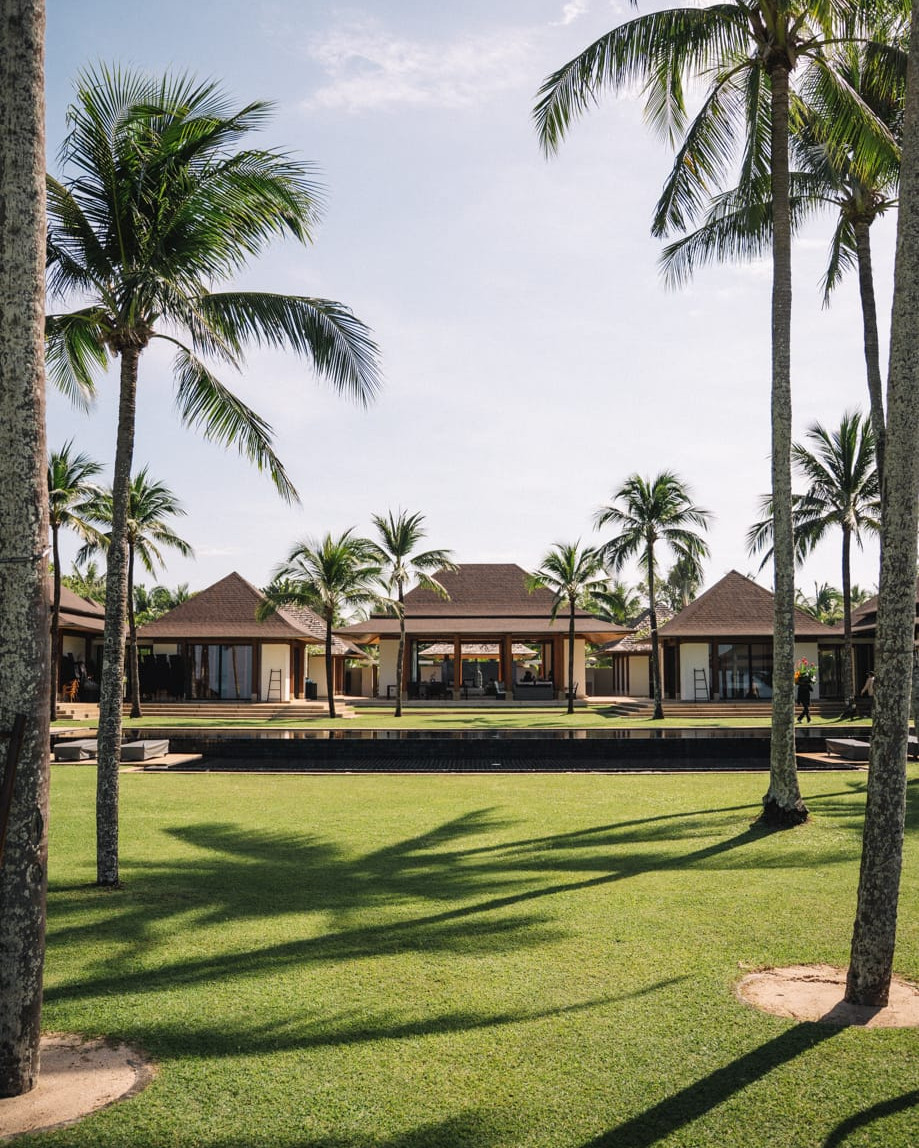 Luxury beachfront villa garden with palm trees for wedding reception in Bali, Indonesia, destination wedding videographer venue