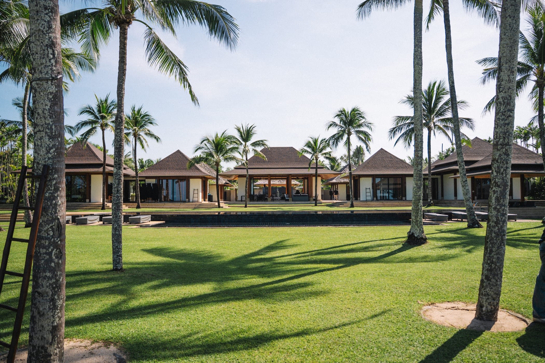 Large lawn surrounded by palm trees at luxury beachfront wedding venue in Phuket