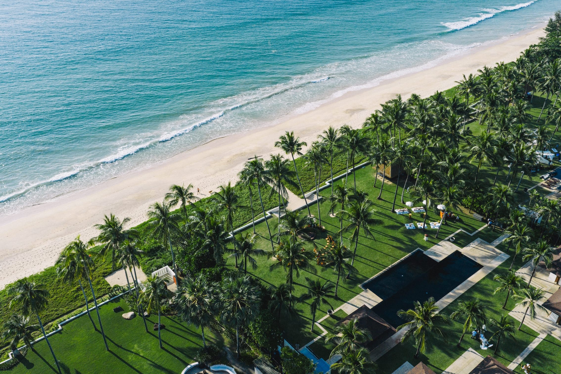 Drone view of luxury beach resort and turquoise sea along the Phuket coastline