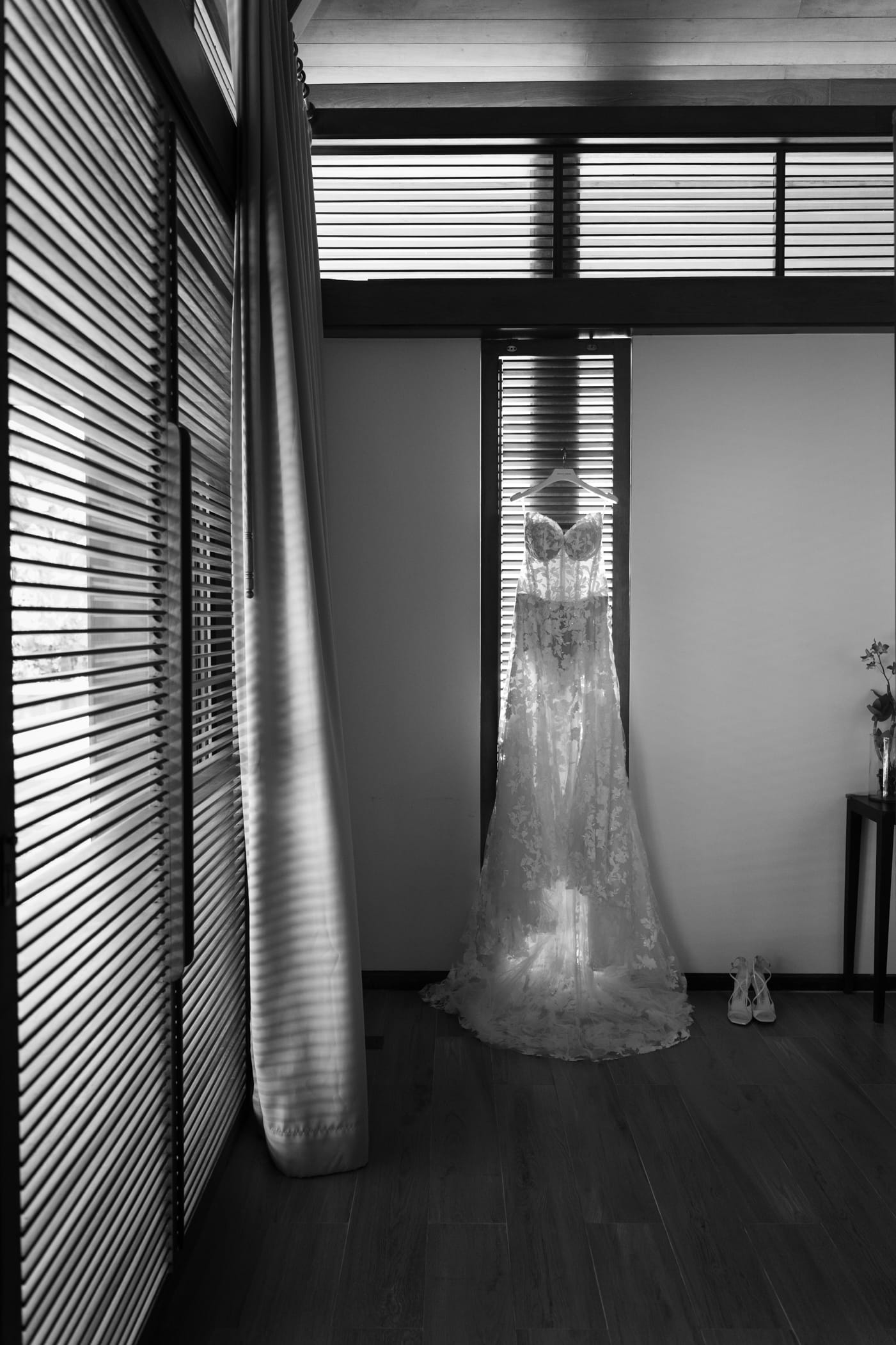 Wedding dress hanging in modern tropical villa room with ocean view