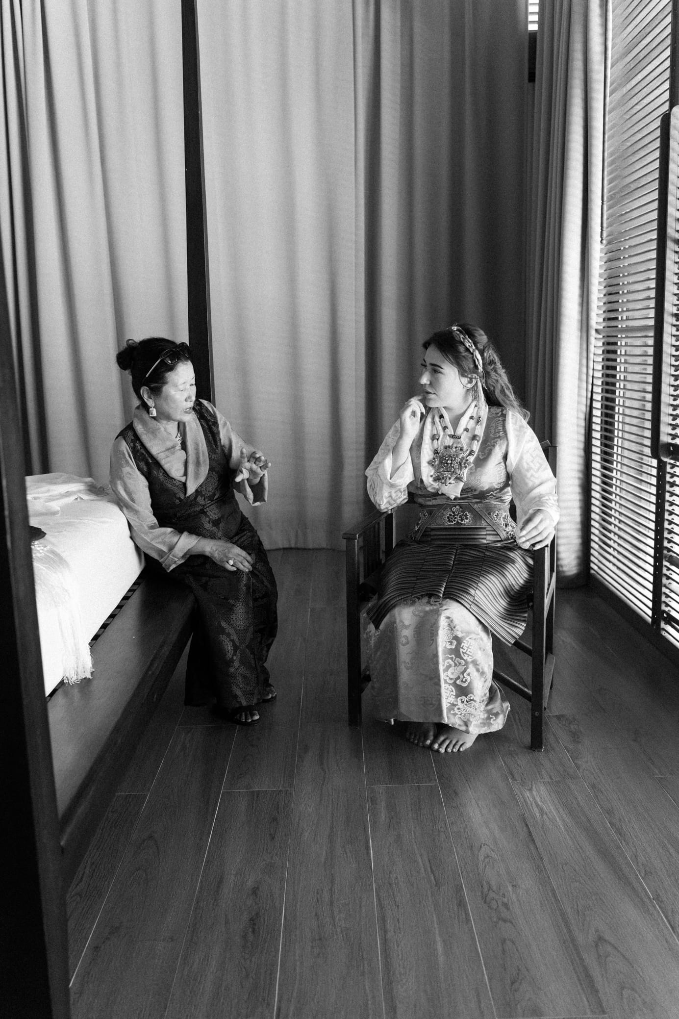 Black and white photo of bride sharing an emotional moment with a friend before the ceremony