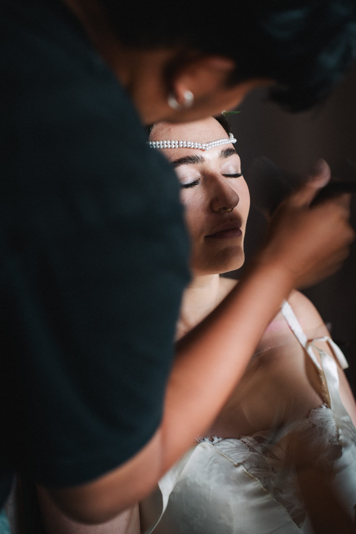 Bride getting ready moment with makeup artist preparing her for the wedding