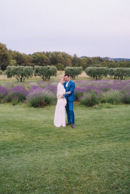 Couple de mariés dans un jardin avec lavande et paysage provençal