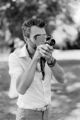 Wedding videographer using super 8 camera to film a wedding