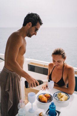 Elopement couple having breakfast on a boat after their wedding day