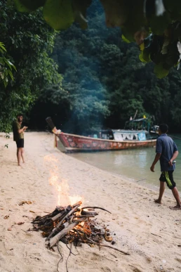 Couple beside a traditional long-tail boat during their multi-day island wedding experience