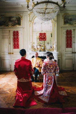 Couple taking part in a Chinese tea ceremony during a multicultural wedding weekend