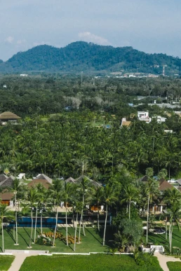 Aerial view of a tropical resort surrounded by forest and mountains in Chiang Mai, Thailand