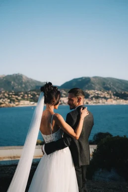 Bride and groom embracing above the Mediterranean coast in Corsica