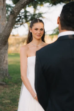 Bride facing the groom during an intimate woodland ceremony in Corsica