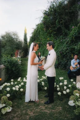 Bride and groom exchanging vows during an intimate garden ceremony in Corsica