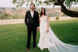 An american couple posing in front of a sicilian landscapes during an elopement ceremony