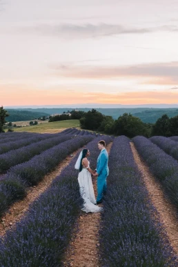 Couple standing between lavender rows at sunset during their elopement in France
