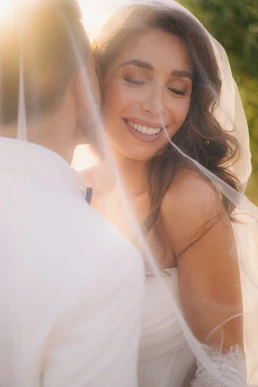 Smiling bride embracing the groom during their elopement in France