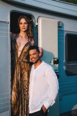 Couple posing beside a blue vintage caravan during their French Riviera elopement