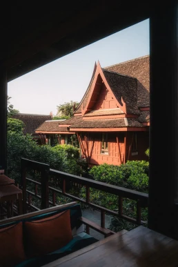 Traditional Thai villa viewed from a shaded wooden terrace in Koh Samui, Thailand