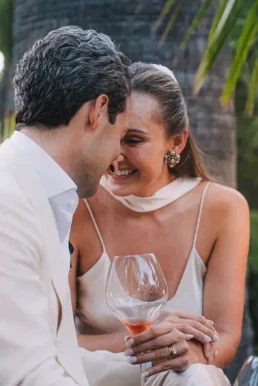 Bride and groom sharing a joyful moment over drinks during their elopement in Koh Samui, Thailand