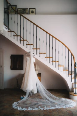 Wedding dress displayed beneath a curved staircase at a Lake Como venue