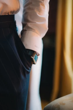 Close-up of a groom fastening his cuff before the ceremony at Château Valmousse