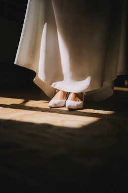 Close-up of the bride's shoes beneath her wedding dress at Château Valmousse