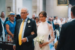 Bride walking down the aisle with her father during the ceremony at Château Valmousse