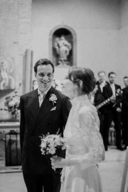 Black-and-white portrait of the groom greeting an older family member during the ceremony at Château Valmousse