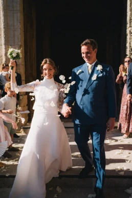 Bride and her father leaving the ceremony as guests throw petals at Château Valmousse