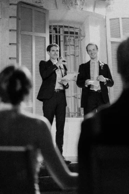 Black-and-white photograph of a guest delivering a wedding speech at Château Valmousse