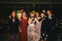 Wedding guests raising glasses during an evening toast at Château Valmousse