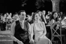 Black-and-white photograph of guests watching the wedding speeches at Château Valmousse