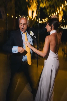 Bride dancing with an older guest during her wedding reception at Château Valmousse