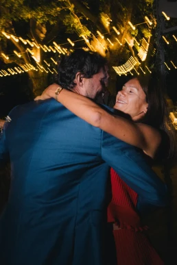 Two wedding guests embracing on the dance floor at Château Valmousse