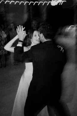 Black-and-white photograph of guests dancing together at a wedding at Château Valmousse