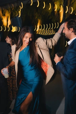 Wedding guest dancing beneath string lights during a reception at Château Valmousse