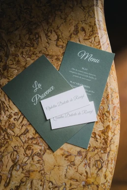 Wedding stationery arranged on patterned fabric at Château Valmousse