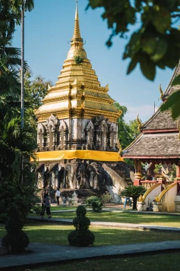 Golden Buddhist temple in a landscaped garden in Phuket, Thailand