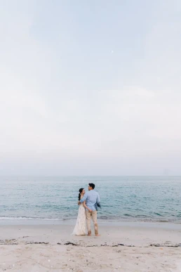 Bride and groom walking alone along the beach during their elopement in Phuket, Thailand
