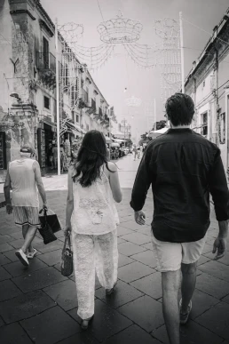 Couple walking hand in hand through a city street during their elopement in Portugal
