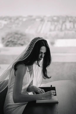 Bride writing a personal letter before her intimate wedding in Portugal