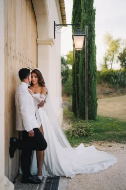 Bride embracing a bridesmaid outside a rustic wedding venue in Portugal