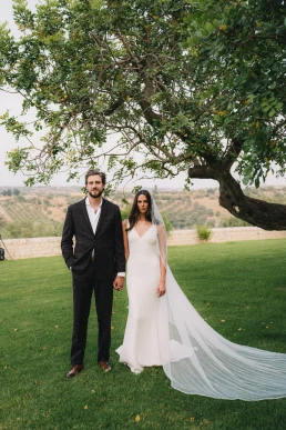 Bride and groom standing beneath an olive tree during their elopement in Provence
