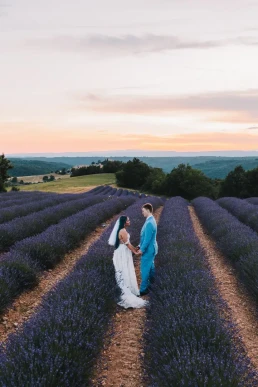 Couple standing between lavender rows at sunset during their elopement in Provence